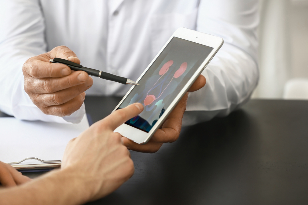 doctor showing bladder diagram on iPad to patient